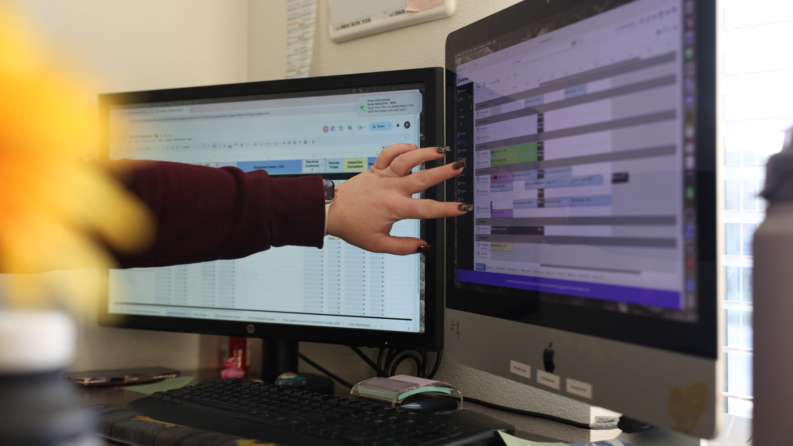 AP worker hand on monitor with ServiceTitan on the screen