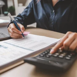 Accountant used a calculator financial analysis managing payroll tax accounting budget accounts.